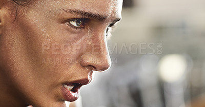 Buy stock photo Cropped shot of a determined looking young woman working out in the gym