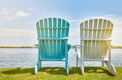 Buy stock photo Blue sky, nature and chair on grass at lake for environment, sitting view and relax in summer. Sunshine, clouds and bench on outdoor field by water for holiday, scenery and vacation in California