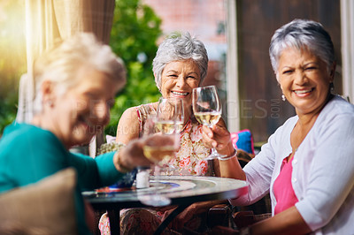 Buy stock photo Cropped portrait of a group of senior female friends toasting during a lunch date