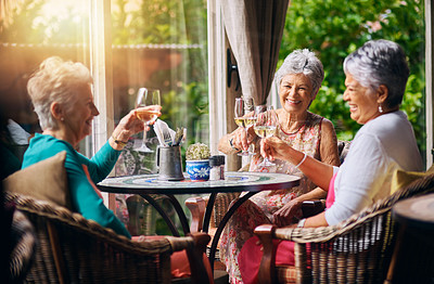 Buy stock photo Cropped shot of a group of senior female friends toasting during a lunch date