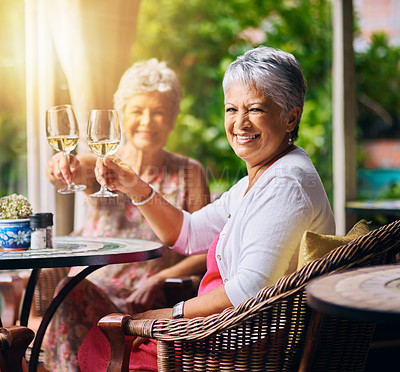 Buy stock photo Cropped portrait of two senior female friends toasting during a lunch date