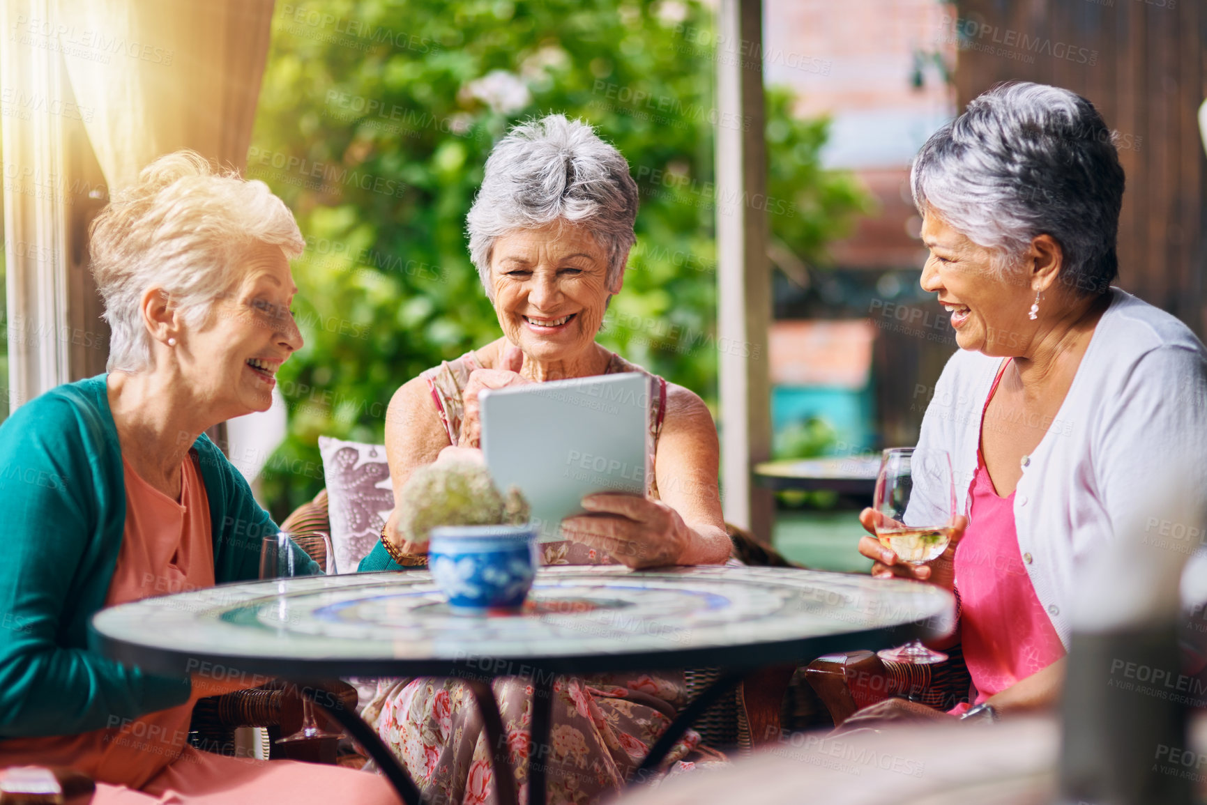 Buy stock photo Senior woman, social and friends with tablet for memory, bonding and laughing while drinking wine. Elderly people, restaurant and relax with technology for internet, joke and vacation with alcohol