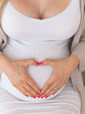 Buy stock photo High angle shot of an unrecognizable pregnant woman sitting down home