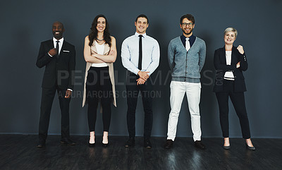 Buy stock photo Studio portrait of a group of businesspeople standing against a grey background