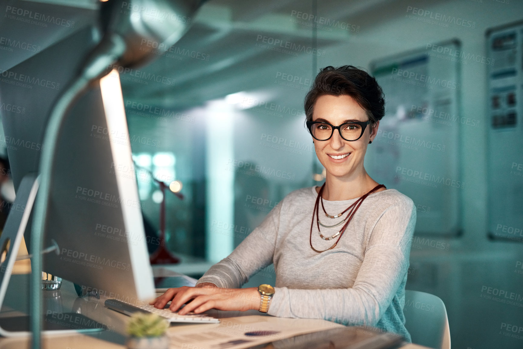 Buy stock photo Shot of a young woman working late at the office