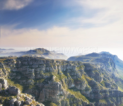 Buy stock photo Copy space with scenic landscape of clouds in the sky covering the peak of Table Mountain in Cape Town on a misty morning. Amazing views from high above a rocky valley after a summit up a mountain 