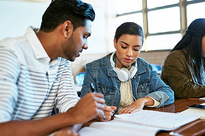 Buy stock photo Cropped shot of two young university students working together in class