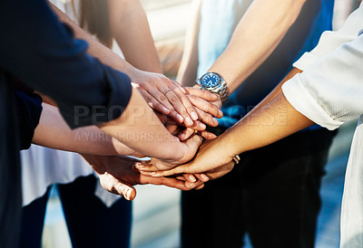 Buy stock photo Cropped shot of an unrecognizable group of people putting their hands together in unity outside