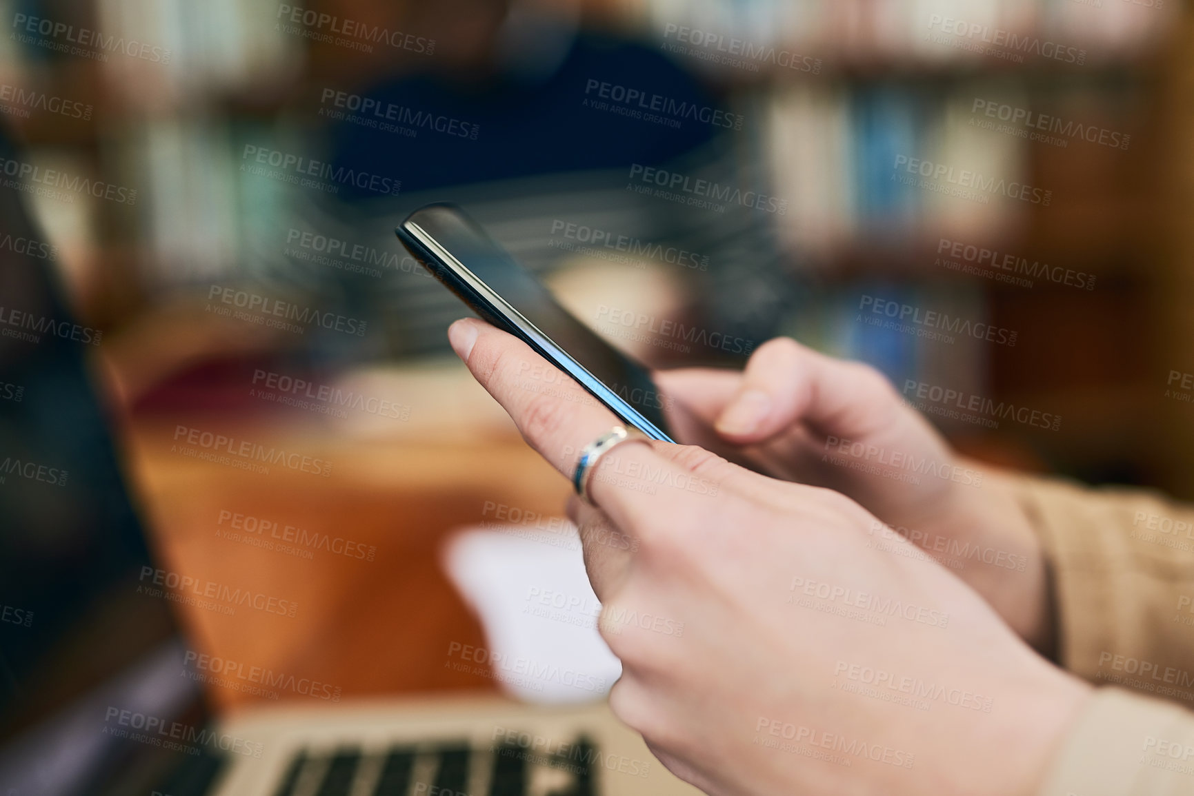 Buy stock photo Phone, library and hands of woman with laptop at university for education, communication or online chat. Computer, smartphone and college student on mobile app for study schedule, research or project