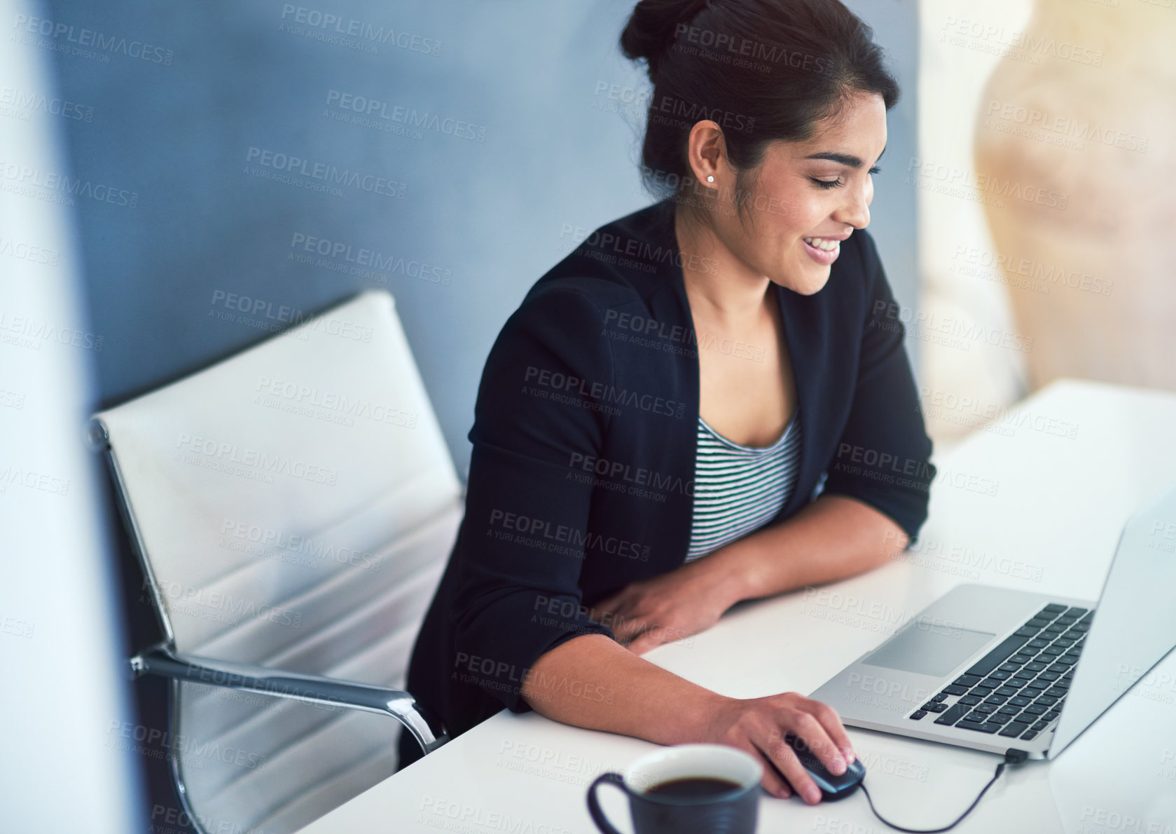 Buy stock photo Cropped shot of an attractive young businesswoman working on a laptop in her office