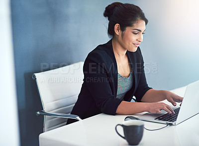 Buy stock photo Cropped shot of an attractive young businesswoman working on a laptop in her office