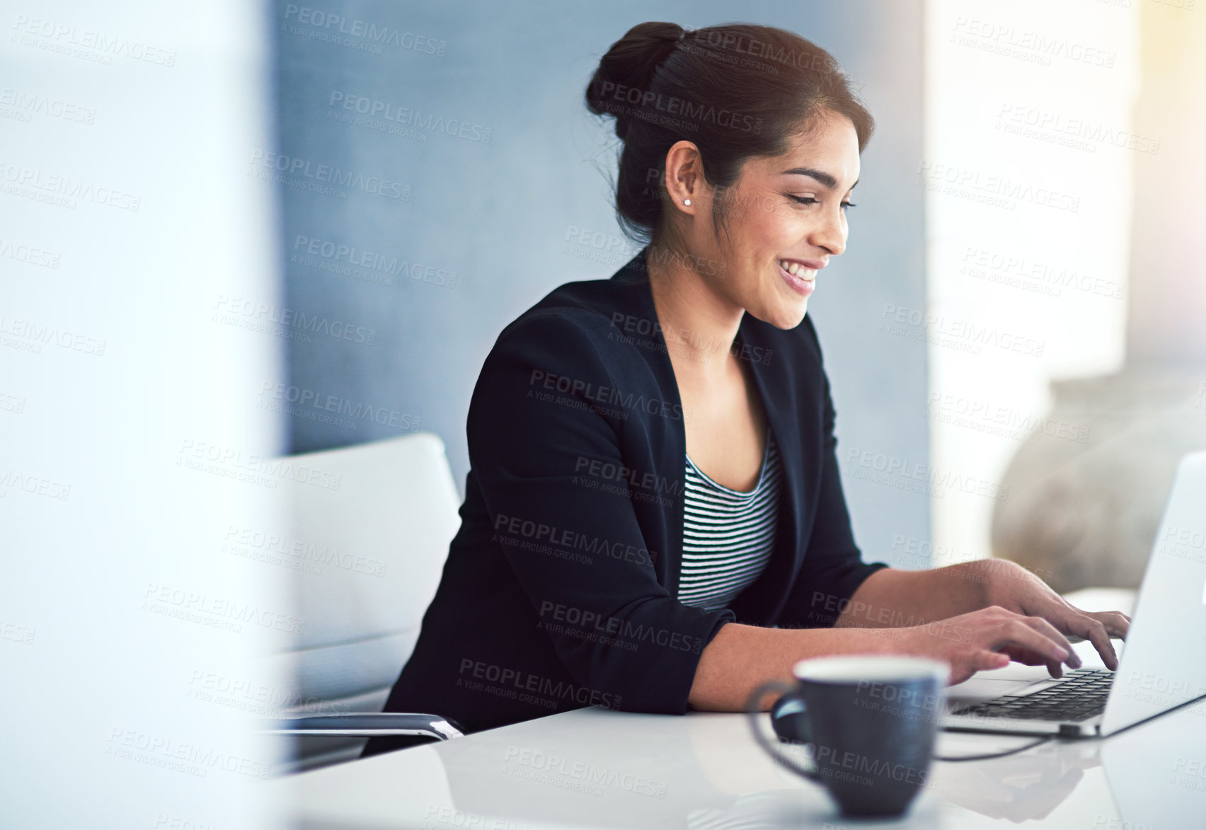 Buy stock photo Cropped shot of an attractive young businesswoman working on a laptop in her office