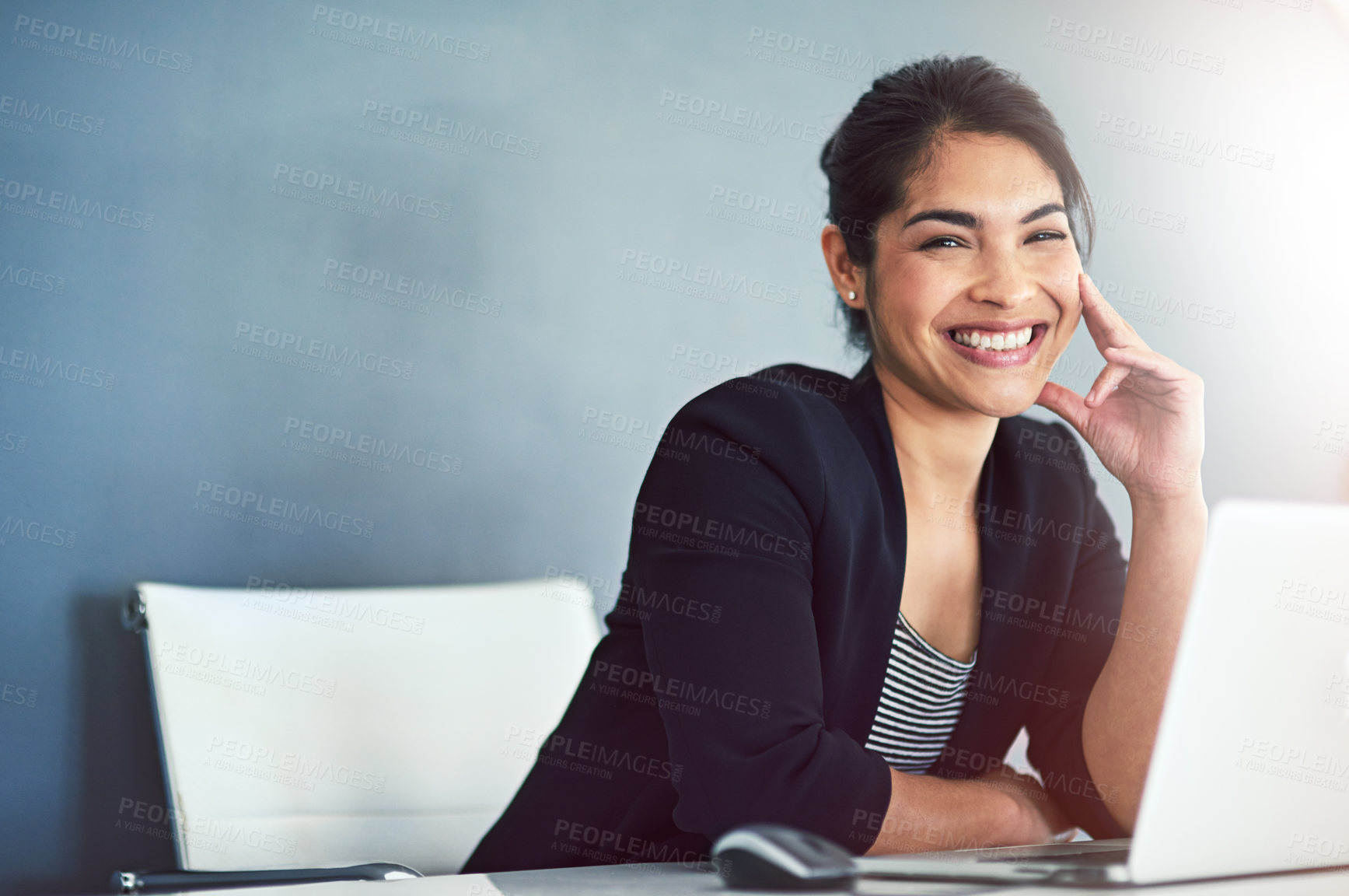 Buy stock photo Cropped portrait of an attractive young businesswoman working on a laptop in her office