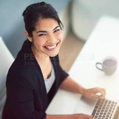 Buy stock photo High angle portrait of an attractive young businesswoman working on a laptop in her office