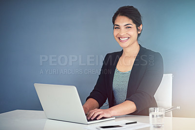 Buy stock photo Cropped portrait of an attractive young businesswoman working on a laptop in her office