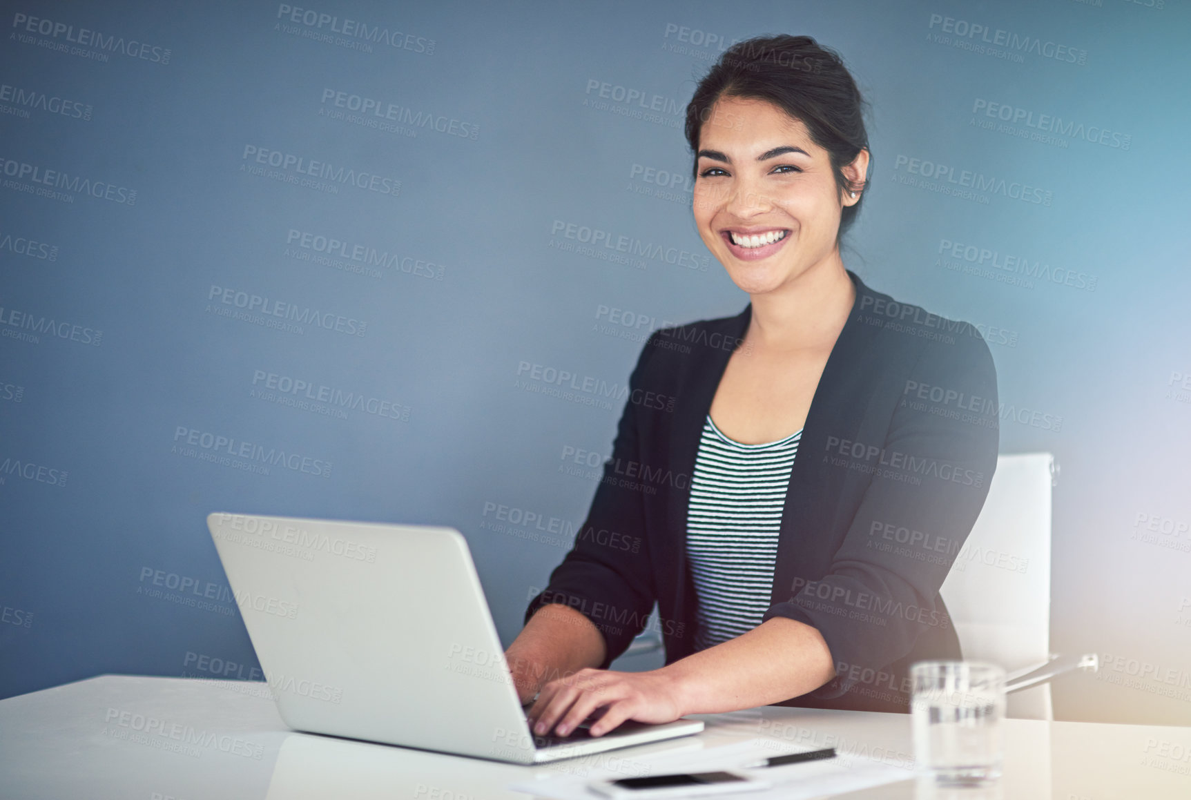 Buy stock photo Cropped portrait of an attractive young businesswoman working on a laptop in her office