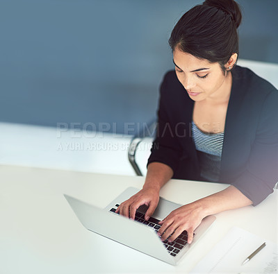 Buy stock photo High angle shot of an attractive young businesswoman working on a laptop in her office