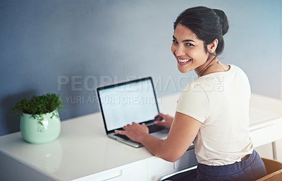 Buy stock photo High angle portrait of an attractive young businesswoman working on a laptop in her office