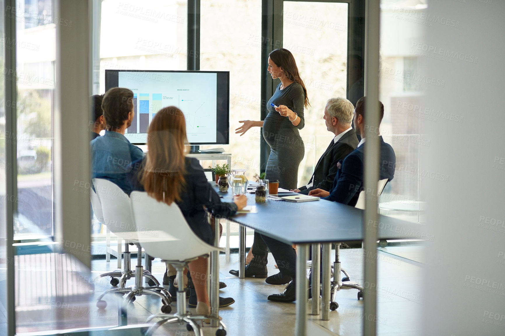 Buy stock photo Shot of a corporate businessperson giving a presentation in the boardroom