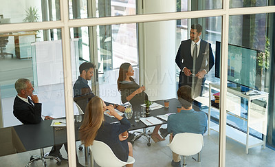 Buy stock photo Shot of a corporate businessperson giving a presentation in the boardroom