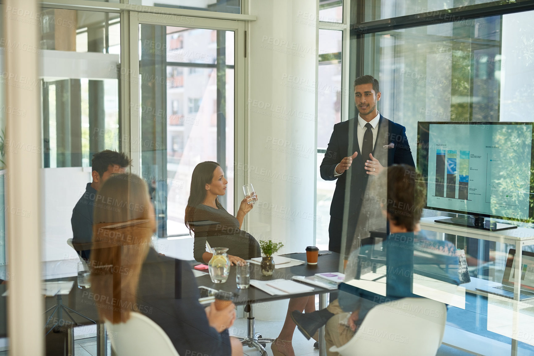 Buy stock photo Shot of a corporate businessperson giving a presentation in the boardroom