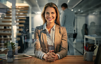 Buy stock photo Portrait of a businesswoman sitting at her desk during a late shift at work