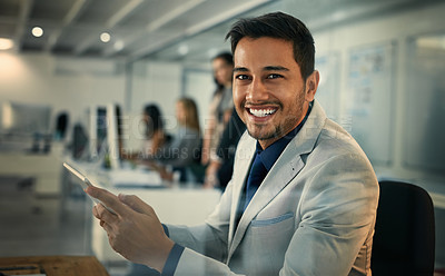 Buy stock photo Portrait of a young businessman using a digital tablet in an office
