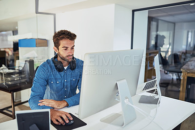 Buy stock photo Cropped shot of a handsome young businessman working in the office