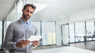Buy stock photo Cropped shot of a handsome young businessman working in the office