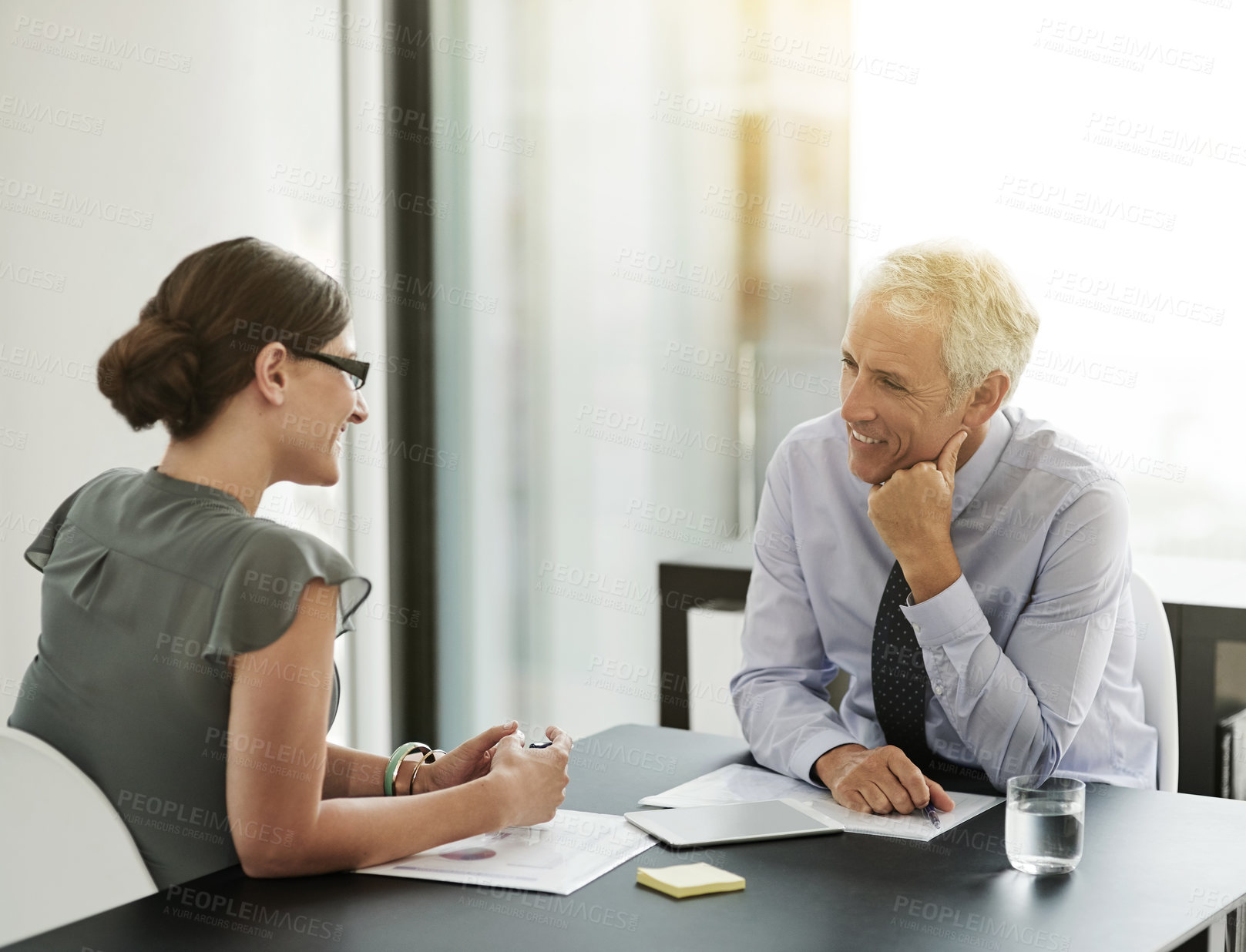 Buy stock photo Business people, partnership and meeting with discussion in office for project feedback and corporate planning. Management, employers and paperwork with digital tech for online research and strategy