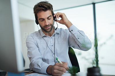 Buy stock photo Writing, advisor or man in telemarketing call center consulting or communication for loan advice. Finance notes, customer support or virtual assistant talking on computer online on headset in office