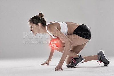 Buy stock photo Studio shot of an athletic young woman ready on her mark against a grey background