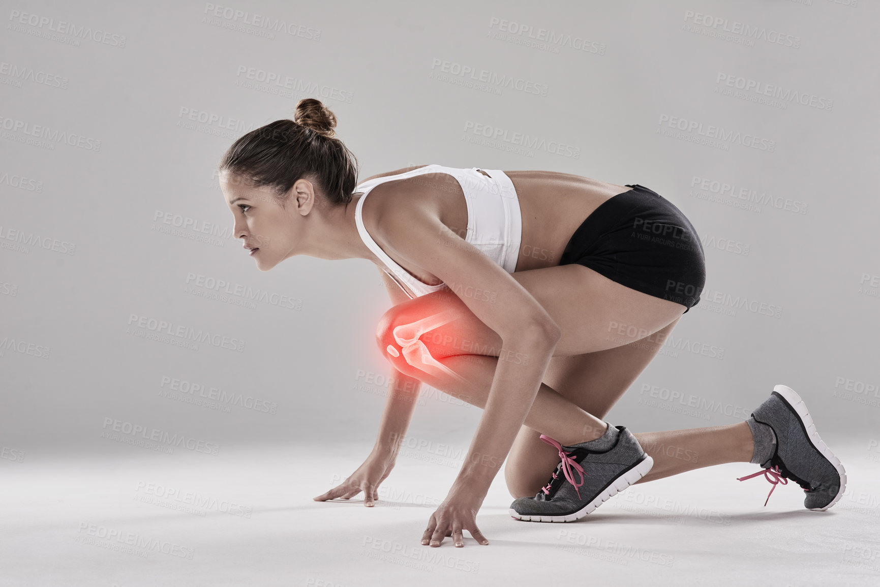 Buy stock photo Studio shot of an athletic young woman ready on her mark against a grey background
