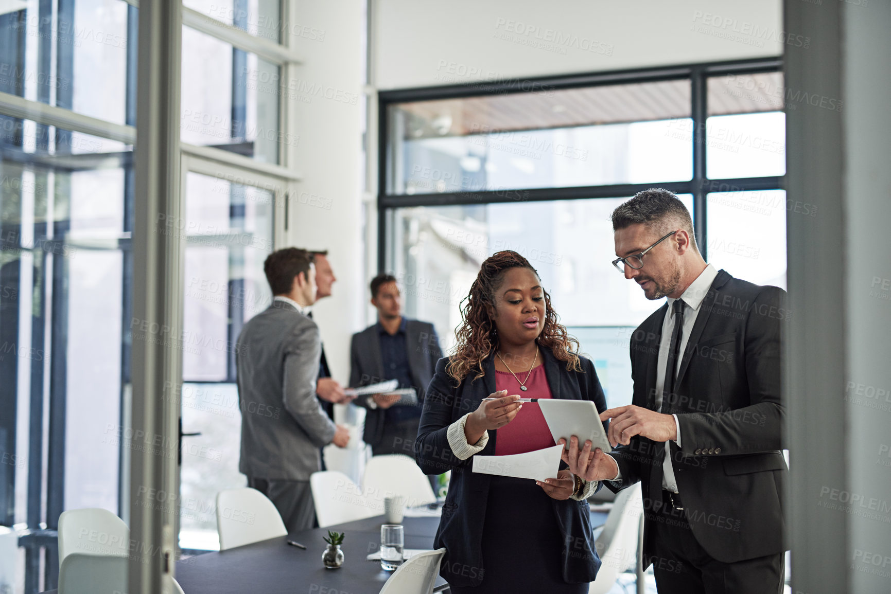 Buy stock photo Shot of corporate businesspeople meeting in the boardroom