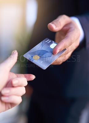 Buy stock photo Cropped shot of a businessman holding out a credit card as payment
