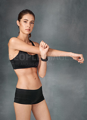 Buy stock photo Studio portrait of a sporty young woman posing against a grey background