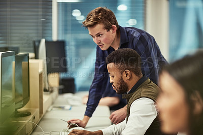 Buy stock photo Shot of a group of designers working on computers in an office