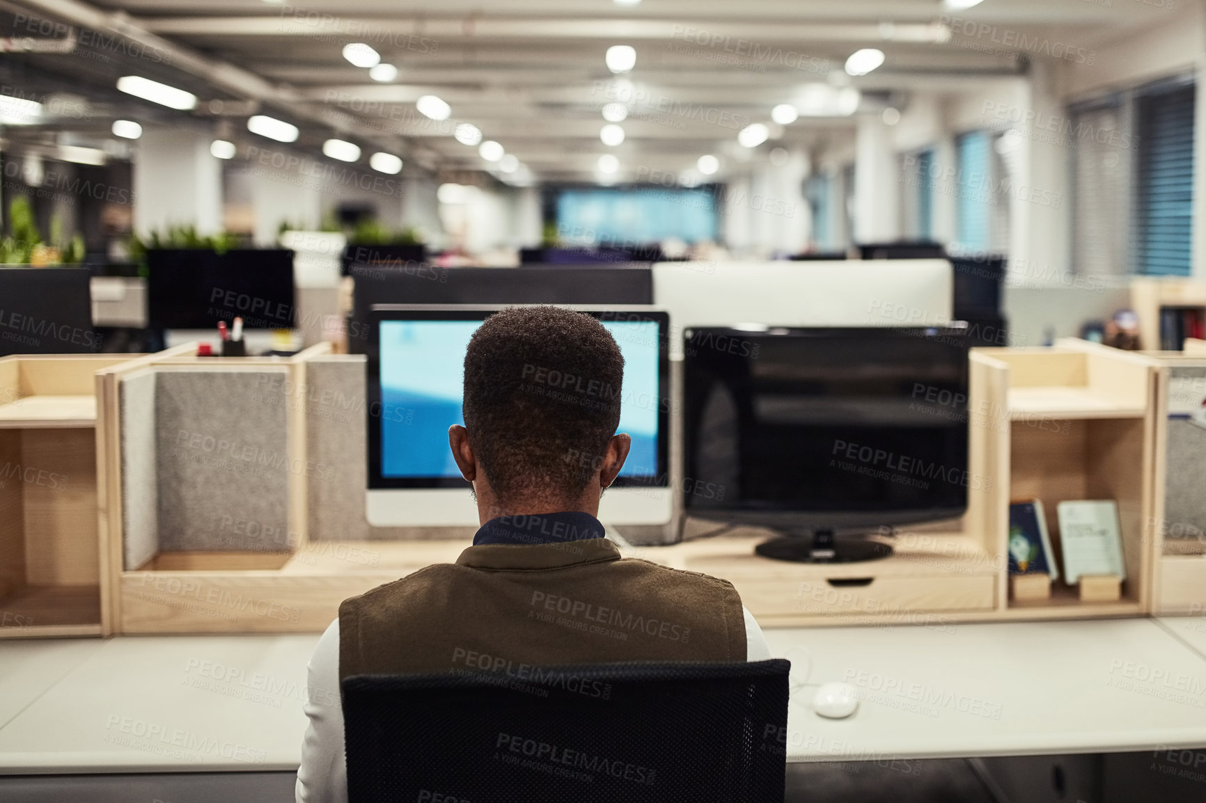 Buy stock photo Rear view shot of a designer working on a computer in an office