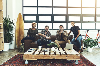 Buy stock photo Shot of a group of designers having fun while playing games