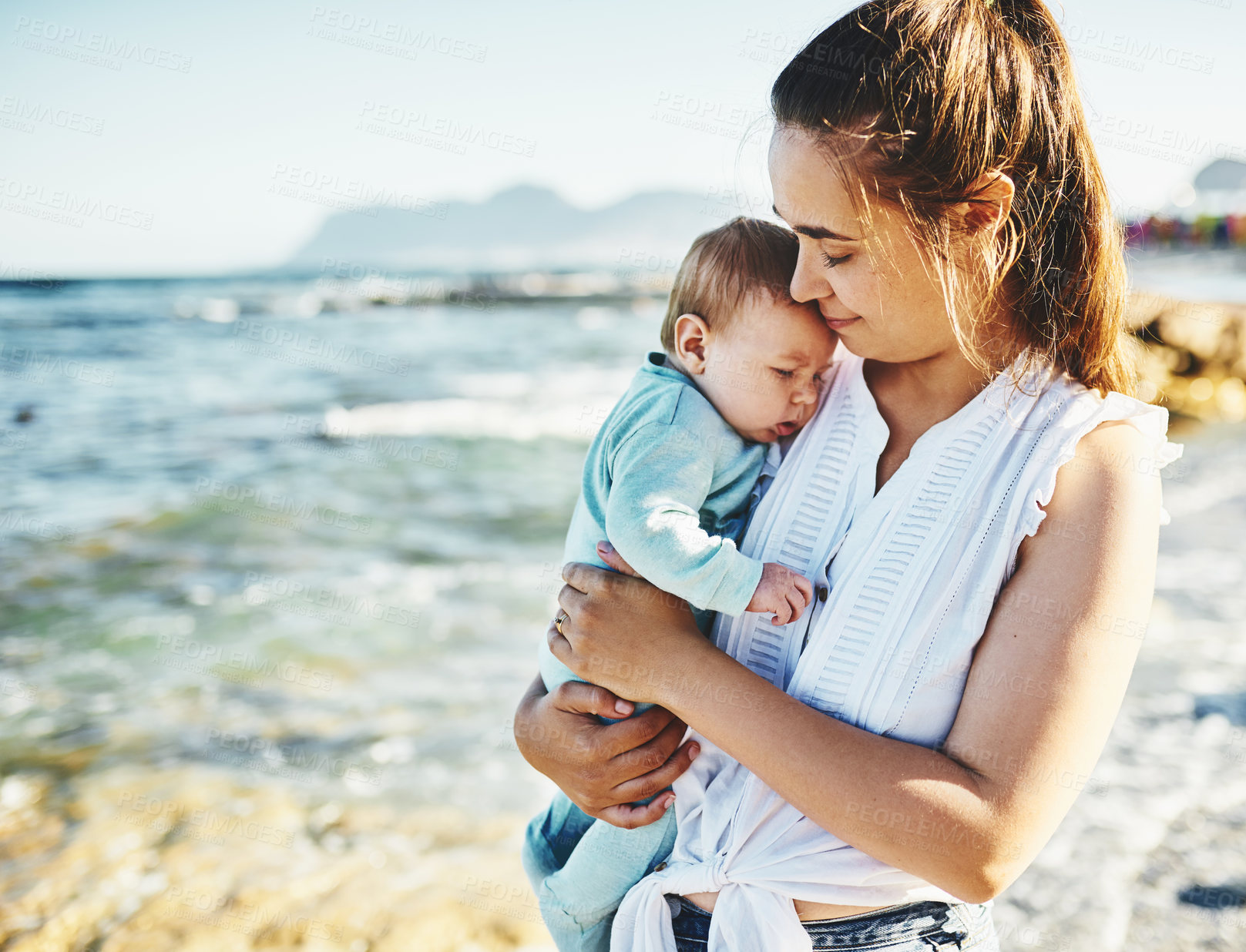 Buy stock photo Travel, mother or newborn at beach for hug, holiday or support in Portugal with boy or family memory. Single parent, mom or baby sleeping at sea for vacation with peace, wellness and nature to relax