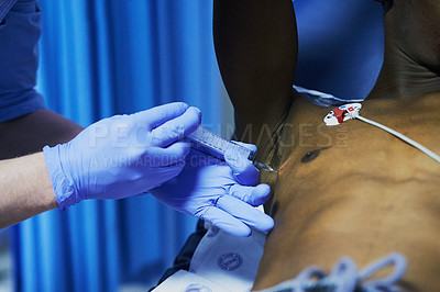 Buy stock photo Cropped shot of a doctor injecting a patient’s arm in an emergency room