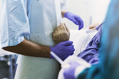 Buy stock photo Cropped shot of a doctor holding a patient by his wrist during a medical procedure