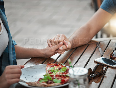 Buy stock photo Cropped shot of two unrecognizable people holding hands around a table outside in a garden
