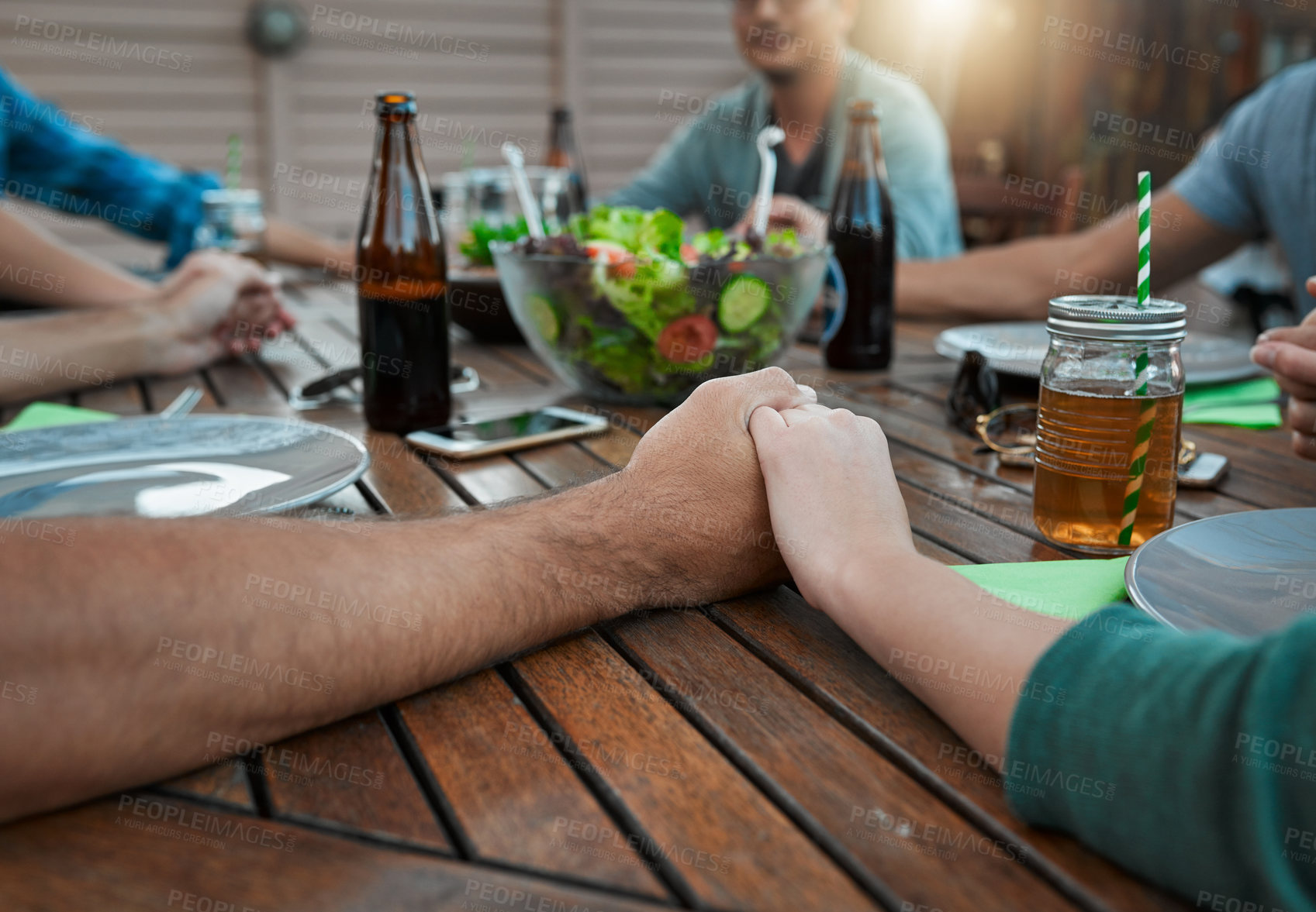 Buy stock photo Christian, holding hands and prayer in group, lunch and gathering for gratitude with feast and people. House, religion and food for thanksgiving, vegan and party in backyard and reunion for friends