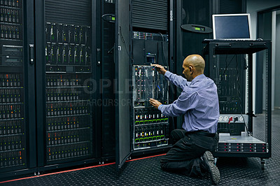 Buy stock photo Database, software and a man engineer in a server room for cybersecurity maintenance on storage hardware. Computer network or mainframe with a technician working on information technology equipment
