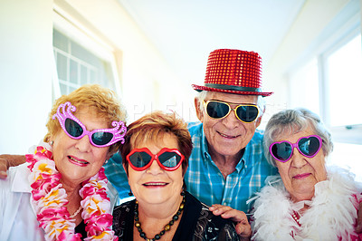 Buy stock photo Shot of a group carefree elderly people wearing glasses and looking at the camera inside of a building