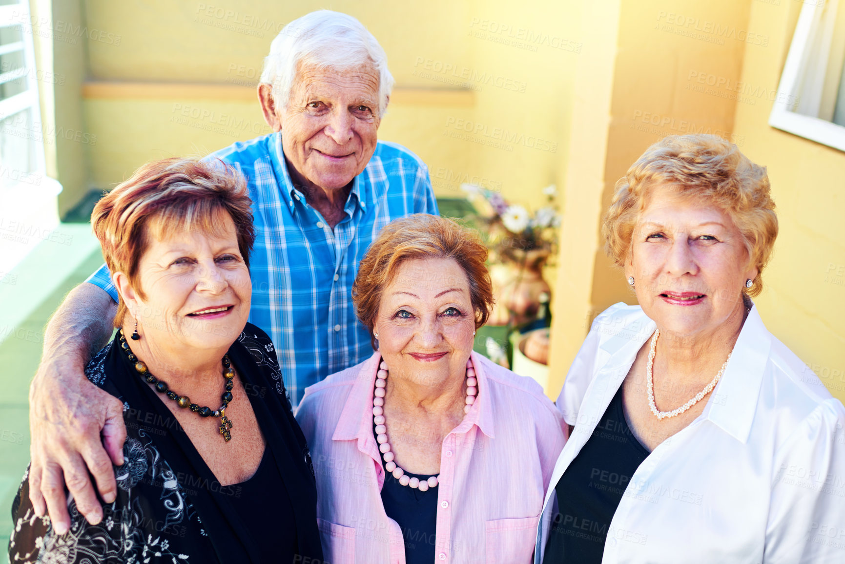 Buy stock photo Shot of a group cheerful elderly people smiling and posing for the camera outside of a building