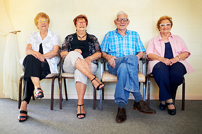 Buy stock photo Shot of a group cheerful elderly people smiling and posing for the camera inside of a building
