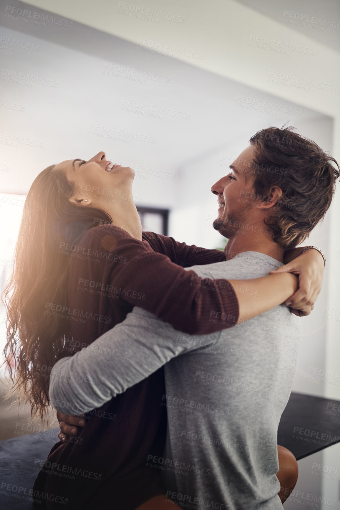 Buy stock photo Couple, hug and laughing on kitchen counter in home with love, bonding and smile together with joy. Embrace, romance and happy people with marriage with care, joke and commitment in house with fun