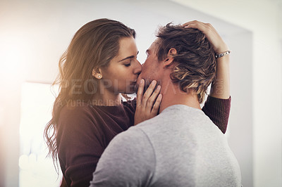 Buy stock photo Couple, love and kissing in home for romantic bond, quality time and care together. Young man, woman and kiss for romance of lovers in happy relationship, intimate moment and passionate affection